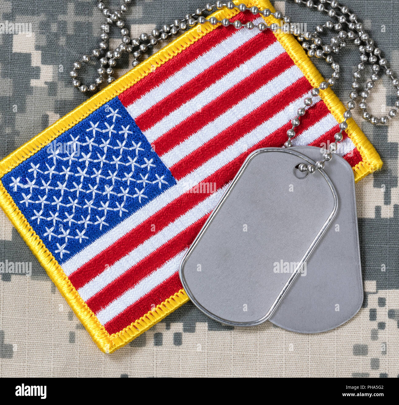 American flag with dog tags on camouflage Stock Photo