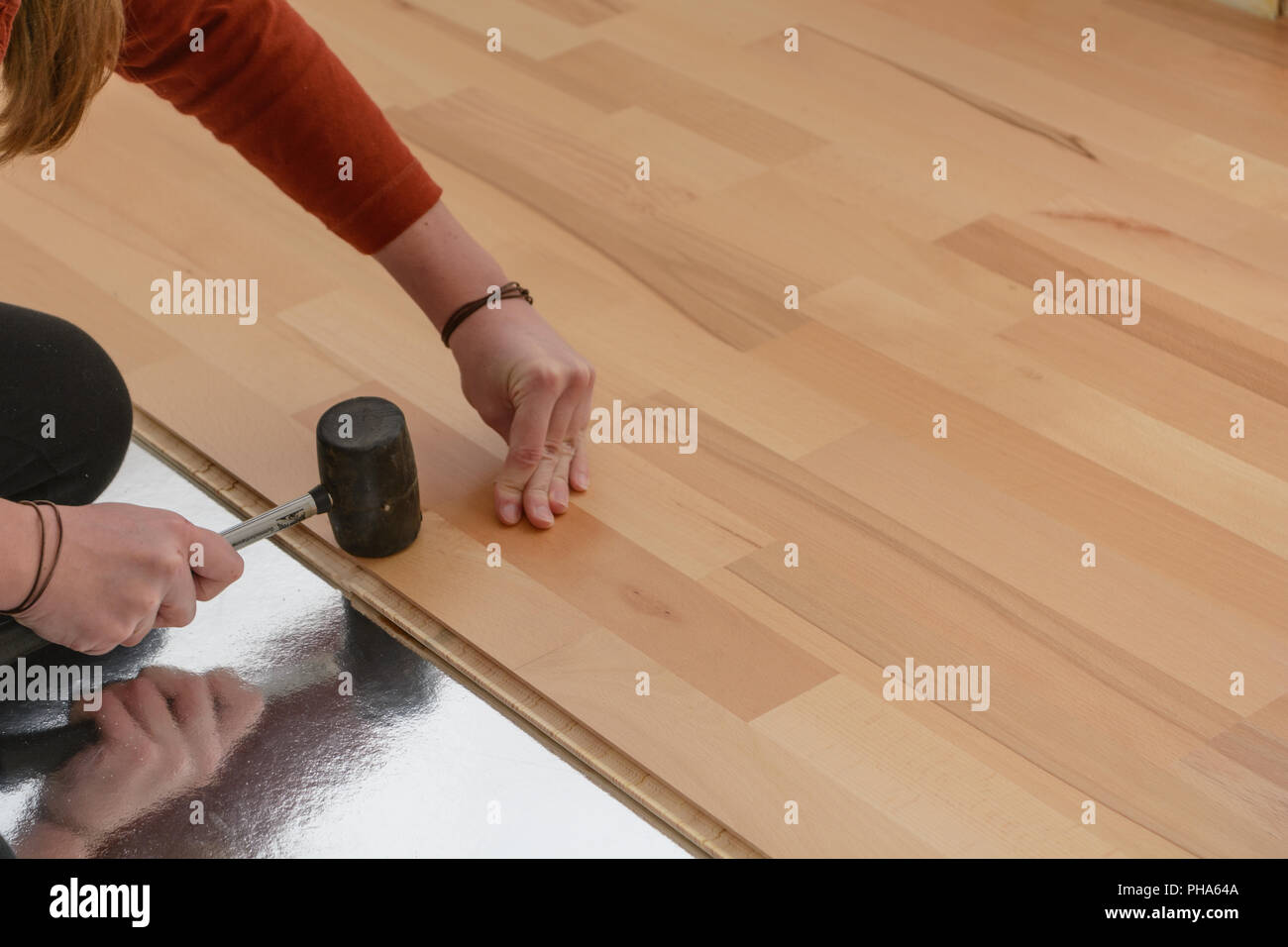 Worker laying a parquet floor - close up of craftwork Stock Photo