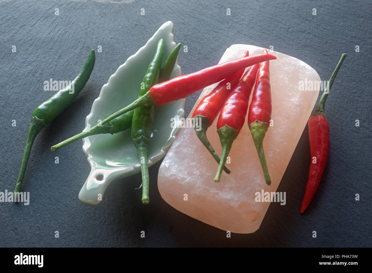 Red and green chilis; rock salt Stock Photo