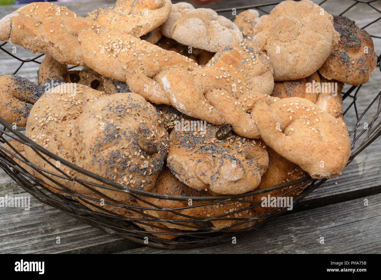 Home-baked whole-grain bread rolls in rusical bread basket Stock Photo