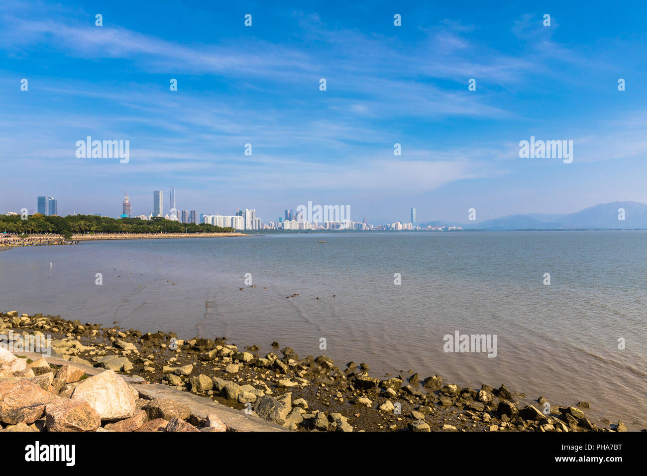Skyline of Shenzhen city from the Shenzhen bay park, the first Special Economic Zone of China, with skyscrapers and  cloudscape on a sunny day, Guangd Stock Photo