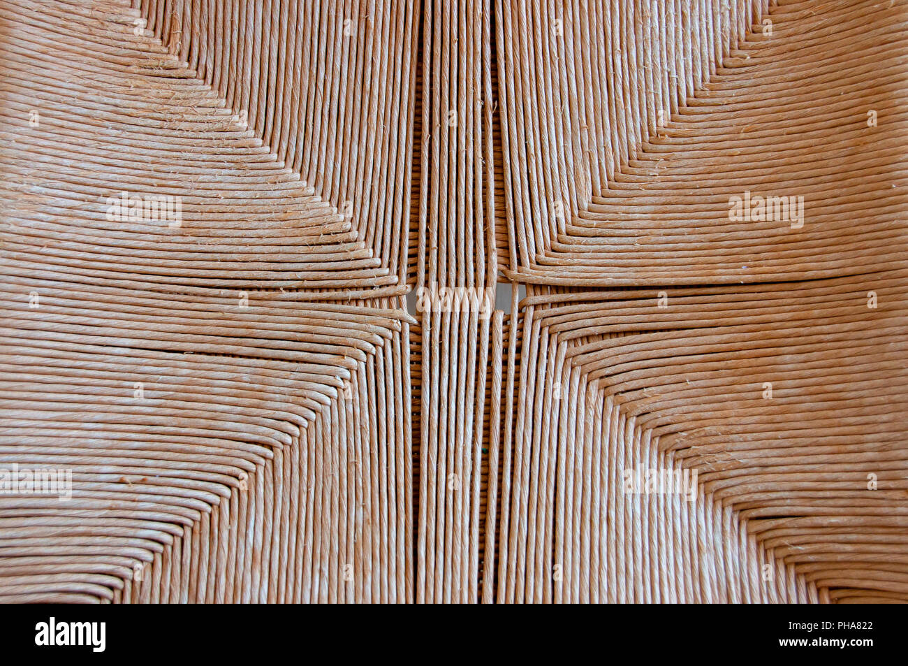 A top view of a cane woven seat pattern on a wooden chair Stock Photo