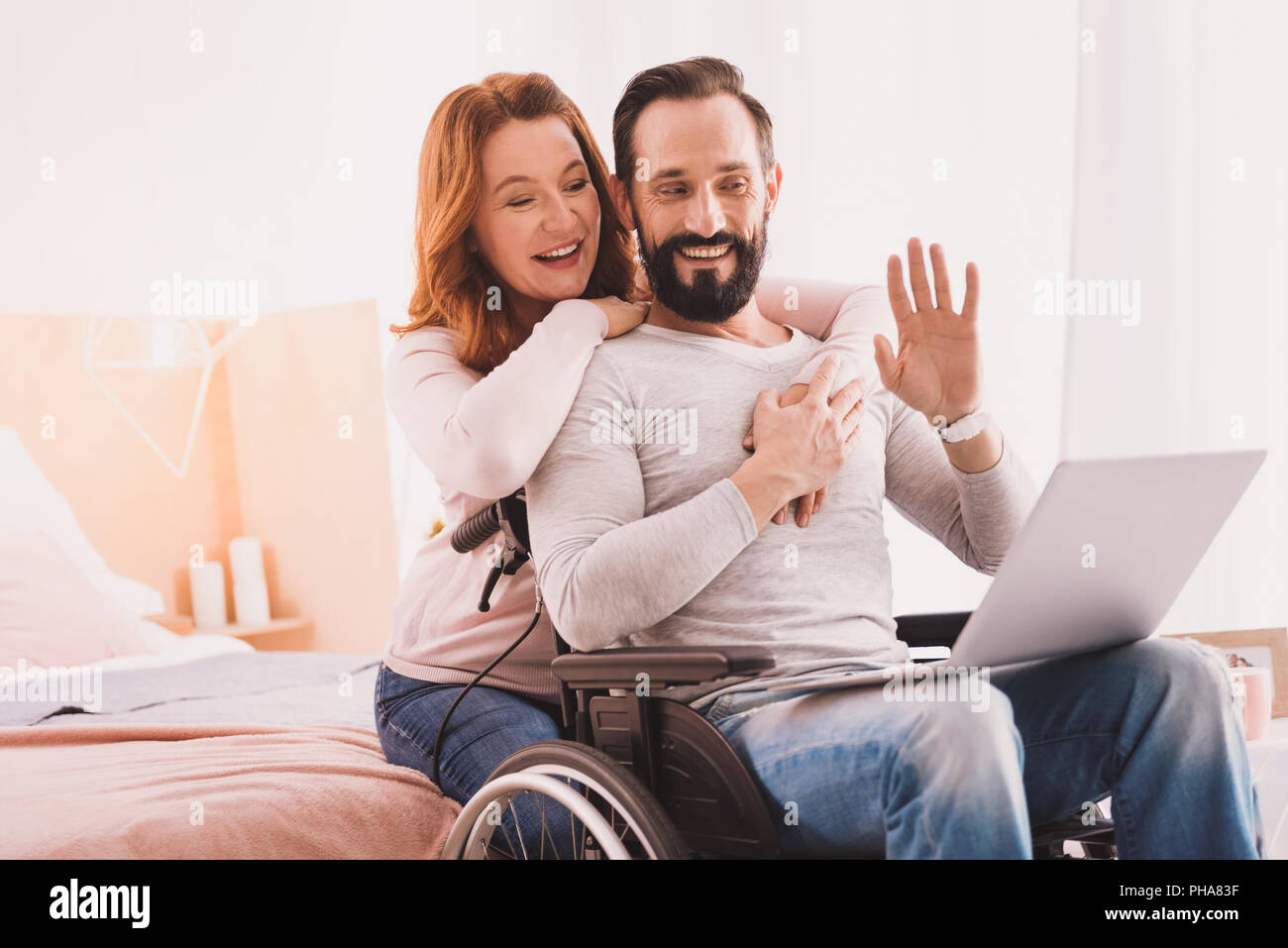 Cheerful couple using a laptop for communication Stock Photo