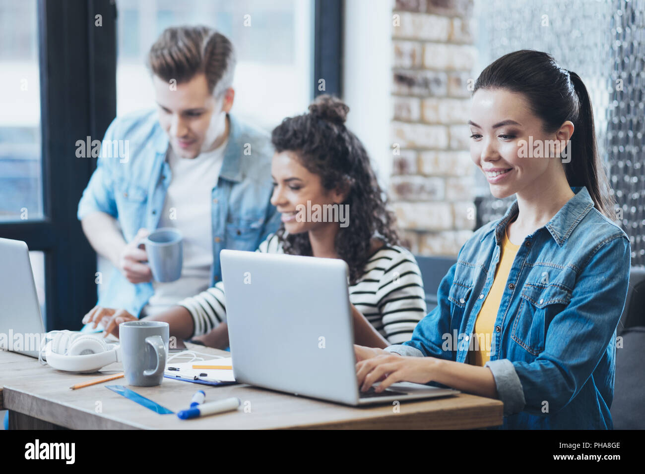 Joyful three students having project Stock Photo