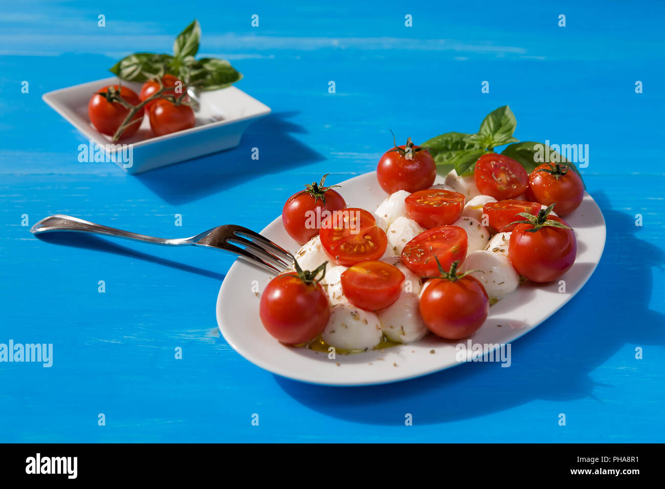 Italian caprese with mozzarella, cherry tomatoes and basil Stock Photo