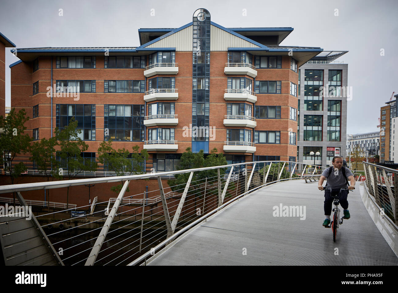 Ralli Quays West Building in Salford with the pedestrian bridge crossing the River Irwell into Manchester Stock Photo