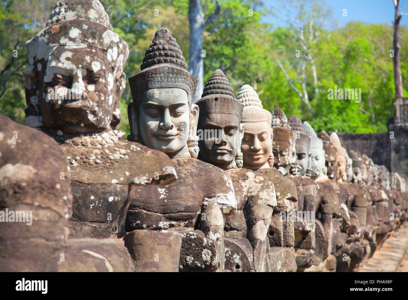 Stone heads guards South Gates of Angkor Thom Stock Photo