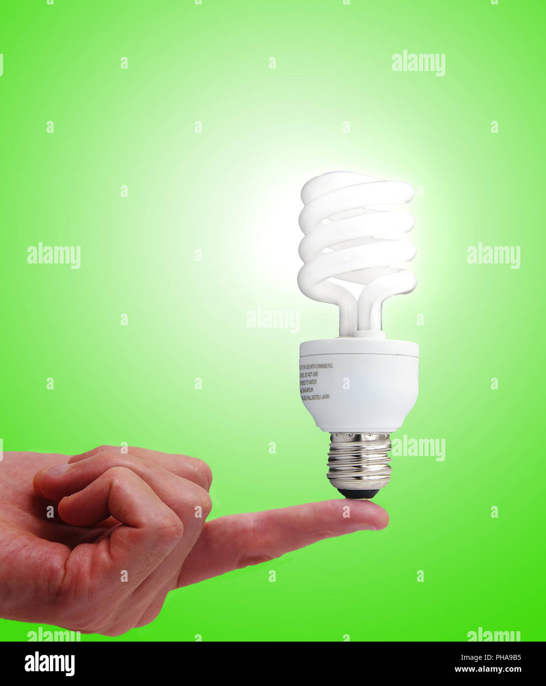 Compact fluorescent bulb on a finger Stock Photo