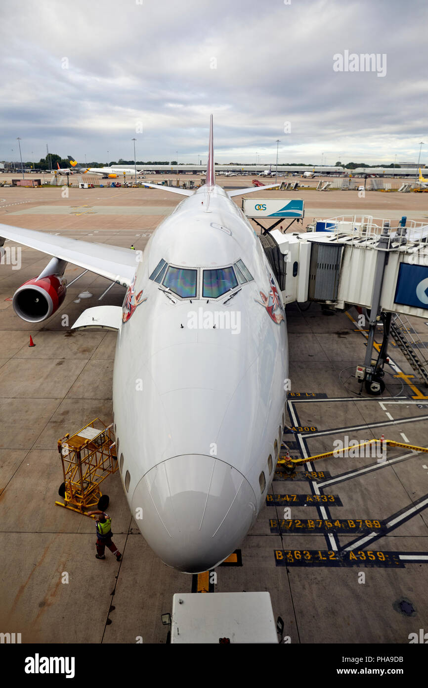 A Virgin Atlantic Boeing 474 - 400 series jumbo jet awn the gate at manchester Airport being catered by OCS Group Stock Photo