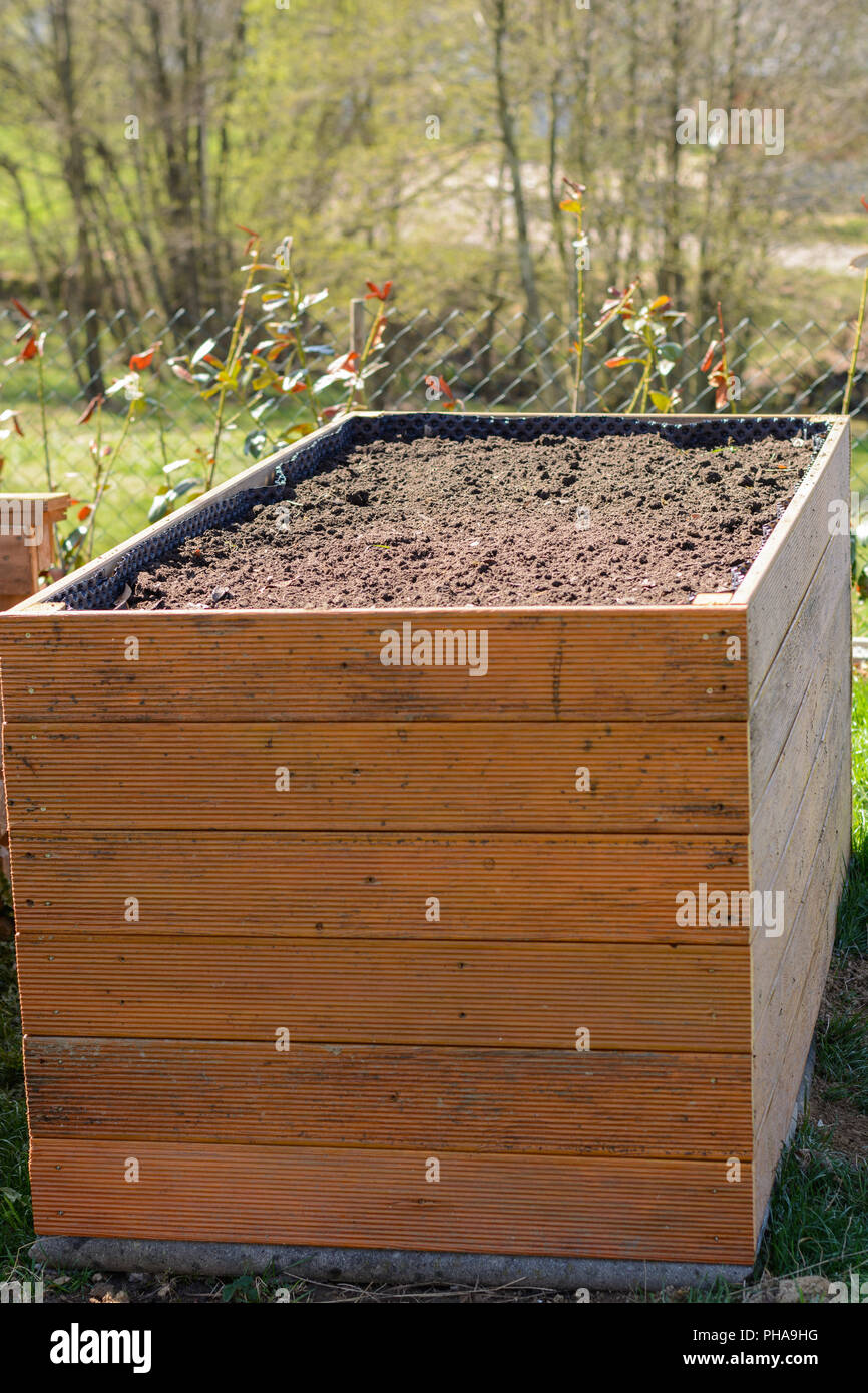 raised bed filled with shrub cut and soil Stock Photo