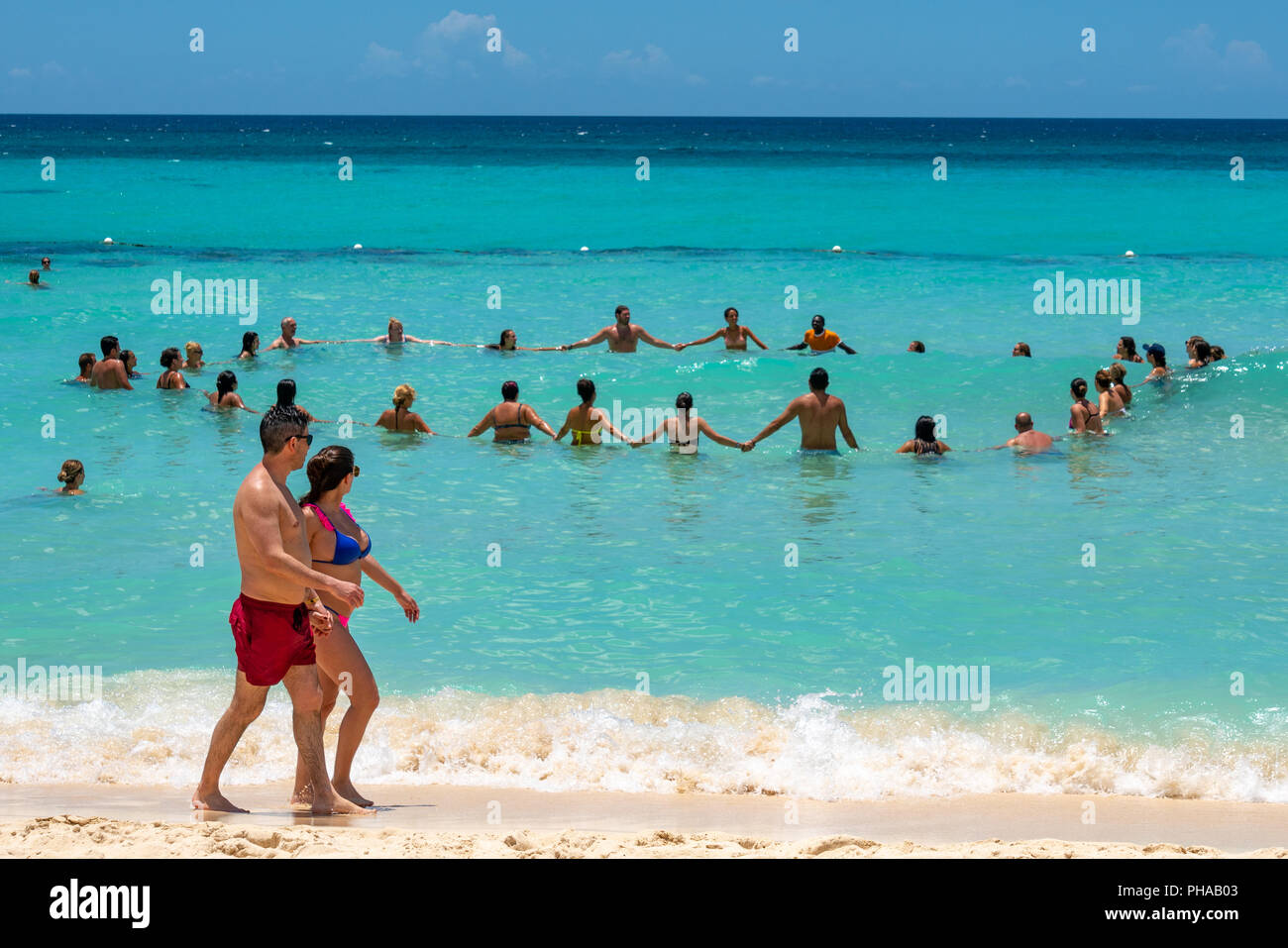Bayahibe, Dominican Republic, 27 August 2018.  Sunbathers watch an aquafit fitness class for tourists at a Caribbean sea resort. Photo by Enrique Shor Stock Photo