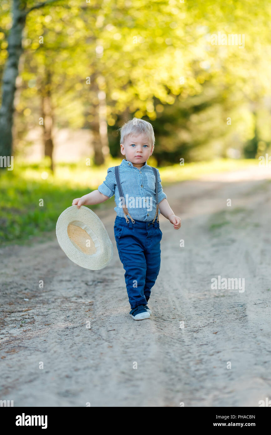 Toddler child outdoors. Rural scene with one year old baby boy with