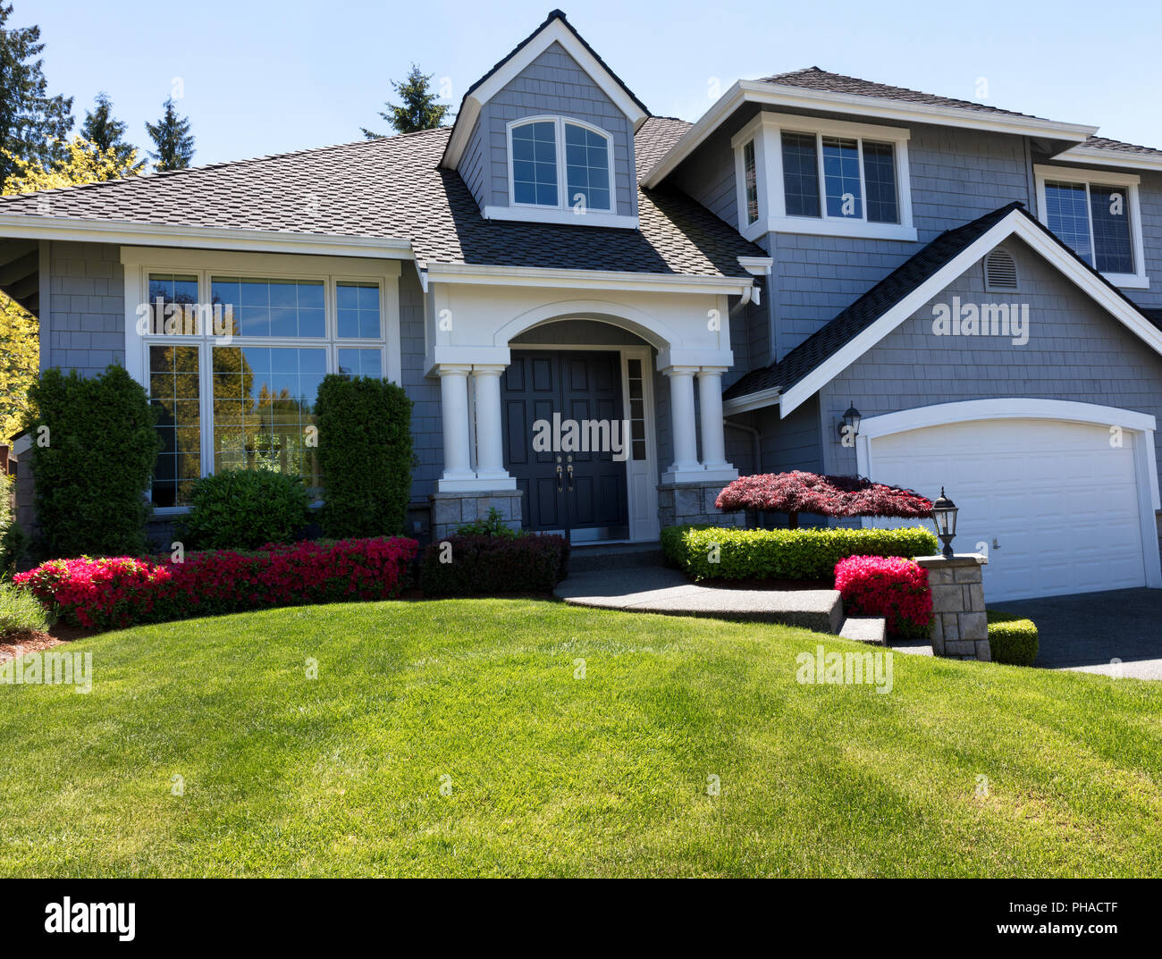Well maintain front lawn of clean home during spring season Stock Photo