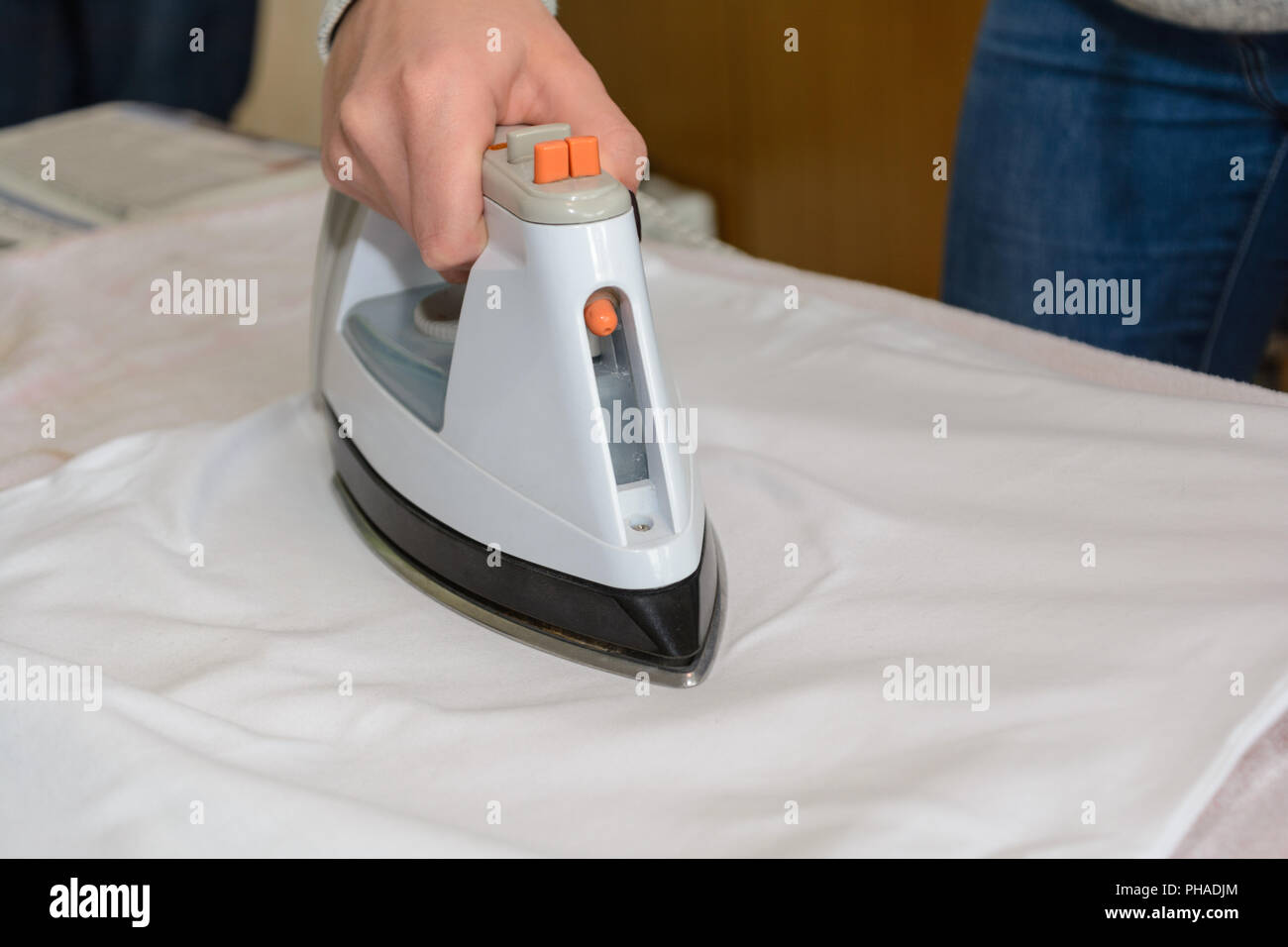 Iron on the ironing table with steam iron Stock Photo
