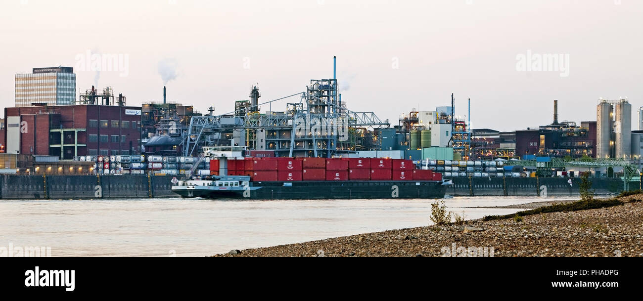 Bayer AG chemical plant and cargo ship on river Rhine, Leverkusen, Germany, Europe Stock Photo