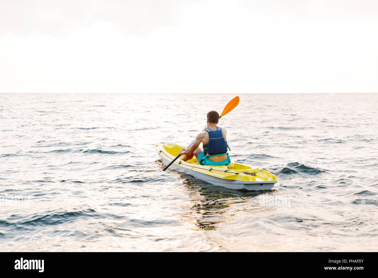 Image of young handsome man kayaking on lake sea in boat Stock Photo ...