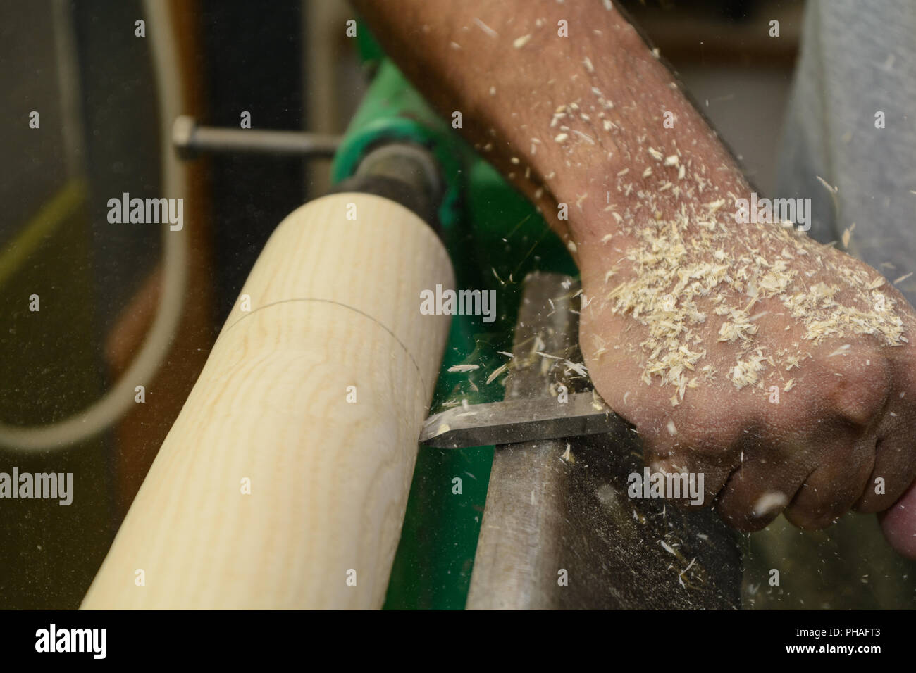 Carpenter in wood turning with a wood chisel - closeup Stock Photo