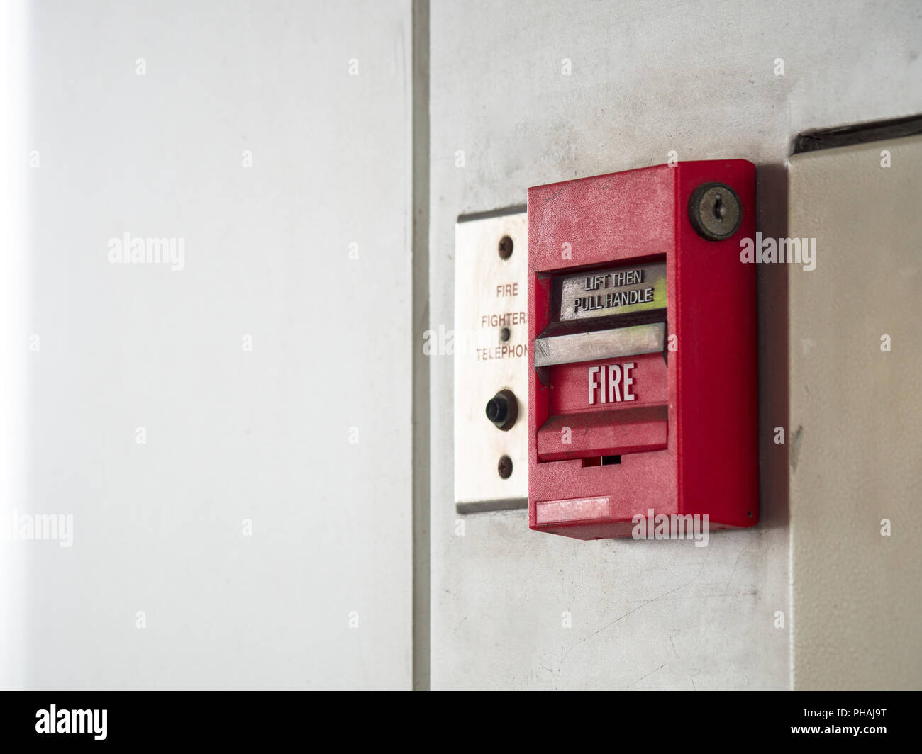 Push button switch, fire alarm on grey wall for alarm and security