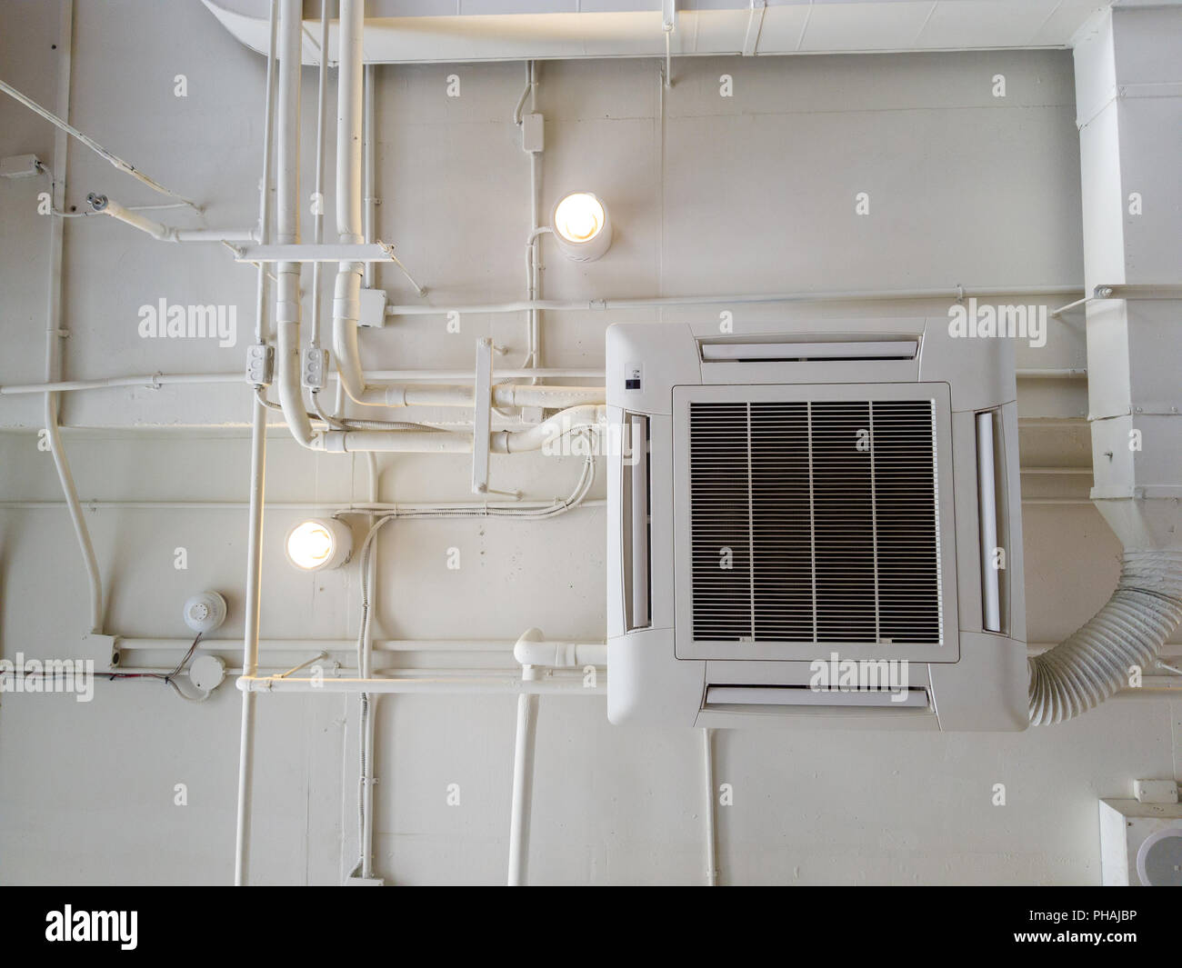 White Industrial air conditioner cooling pipe with plumbing at ceiling