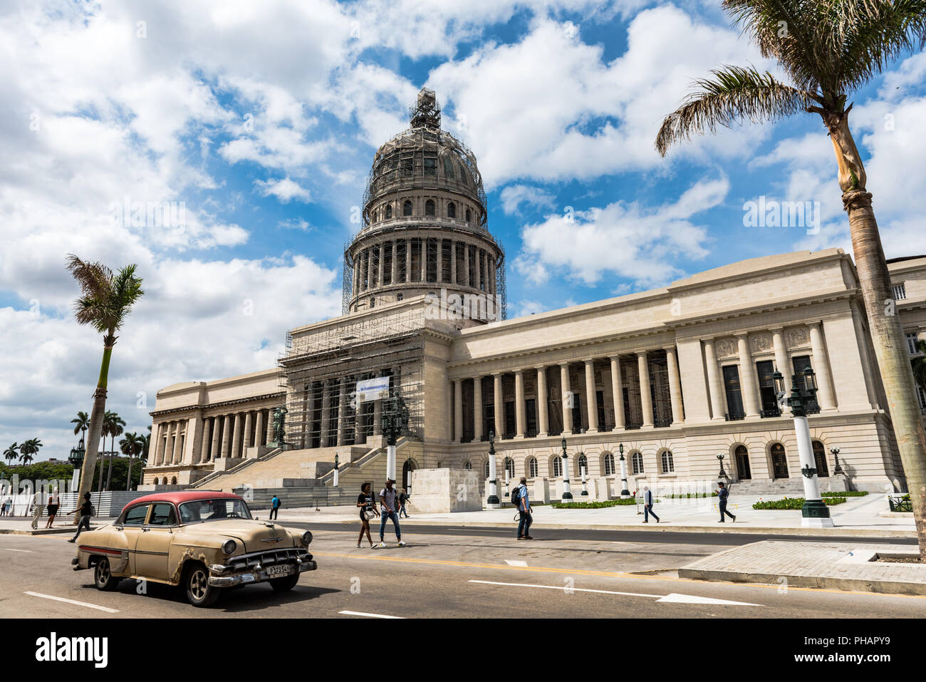 Retro car passes in front of Capitol building in Havana, Cuba. Stock Photo