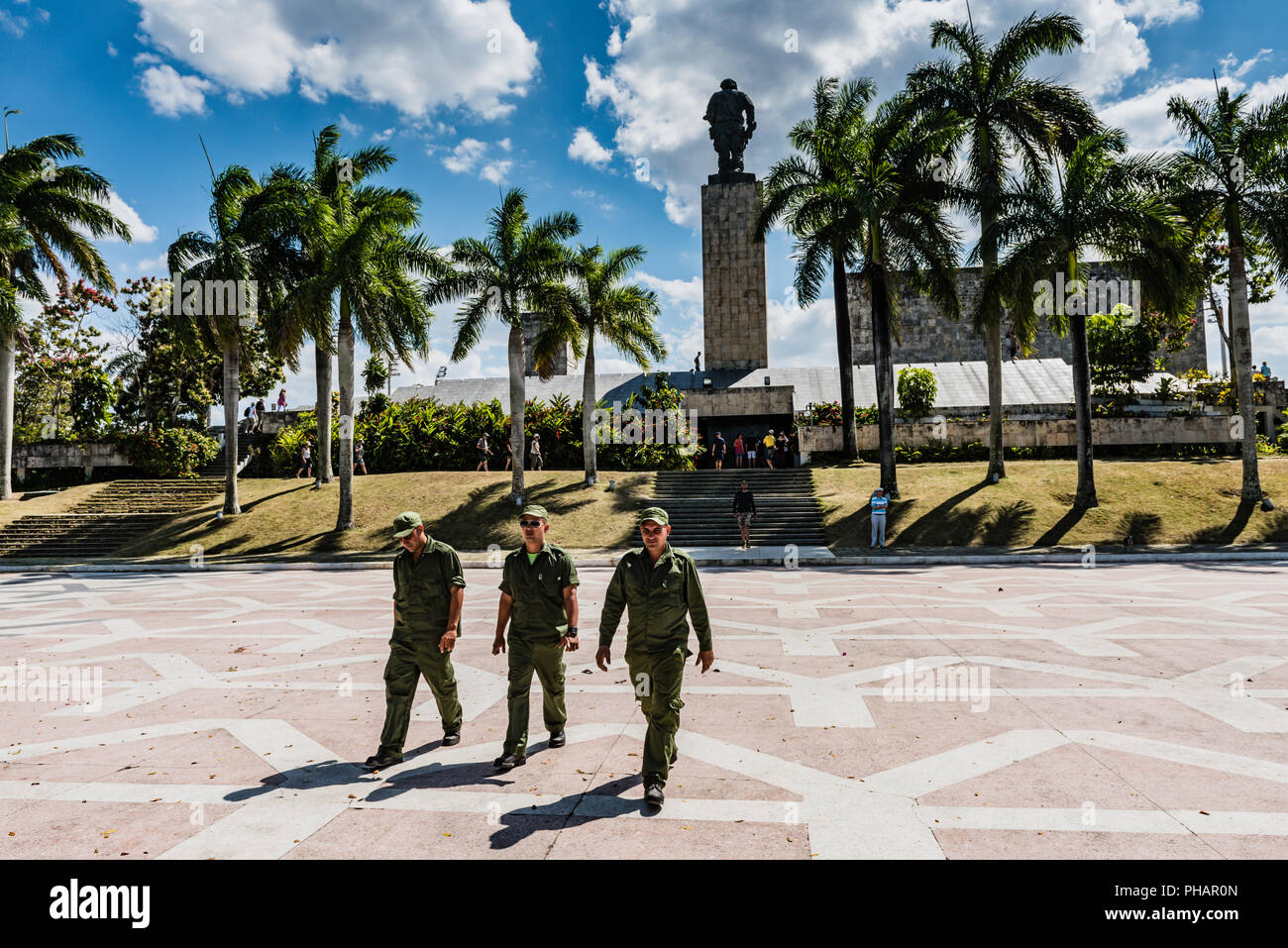 Santa Clara, Cuba / March 16, 2016: Three Cuban soldiers in green fatigues crossing plaza at the Che Guevara Mausoleum. Stock Photo