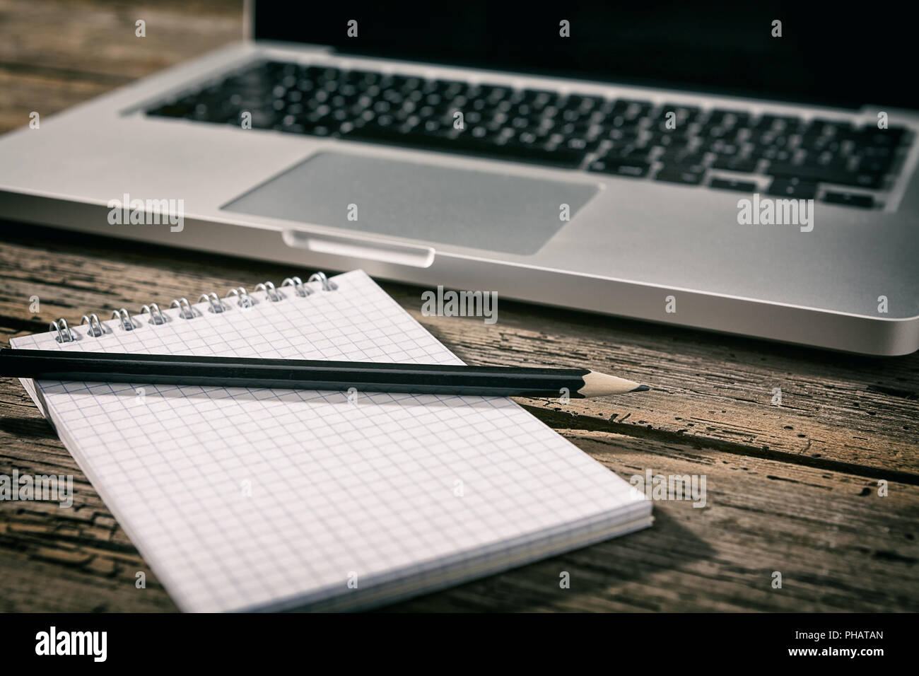 Office workstation with laptop, notebook and pencil Stock Photo