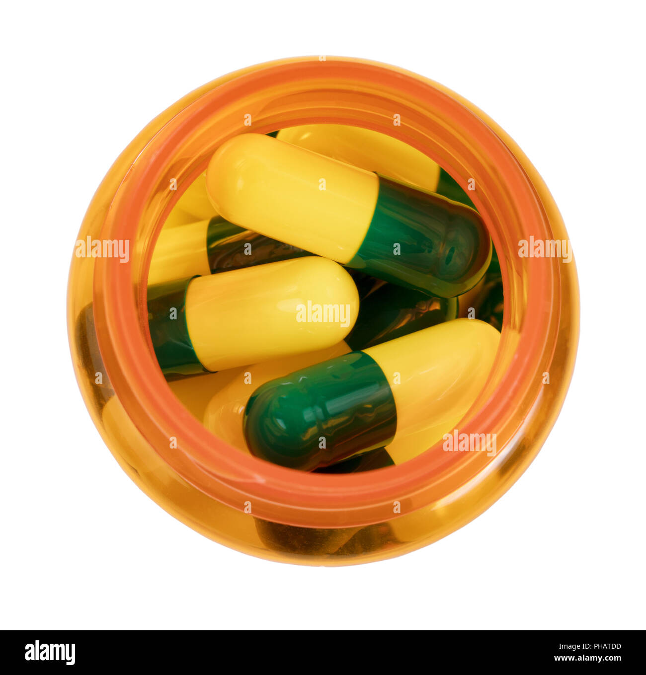 Medicine bottle filled with capsules isolated on white background Stock