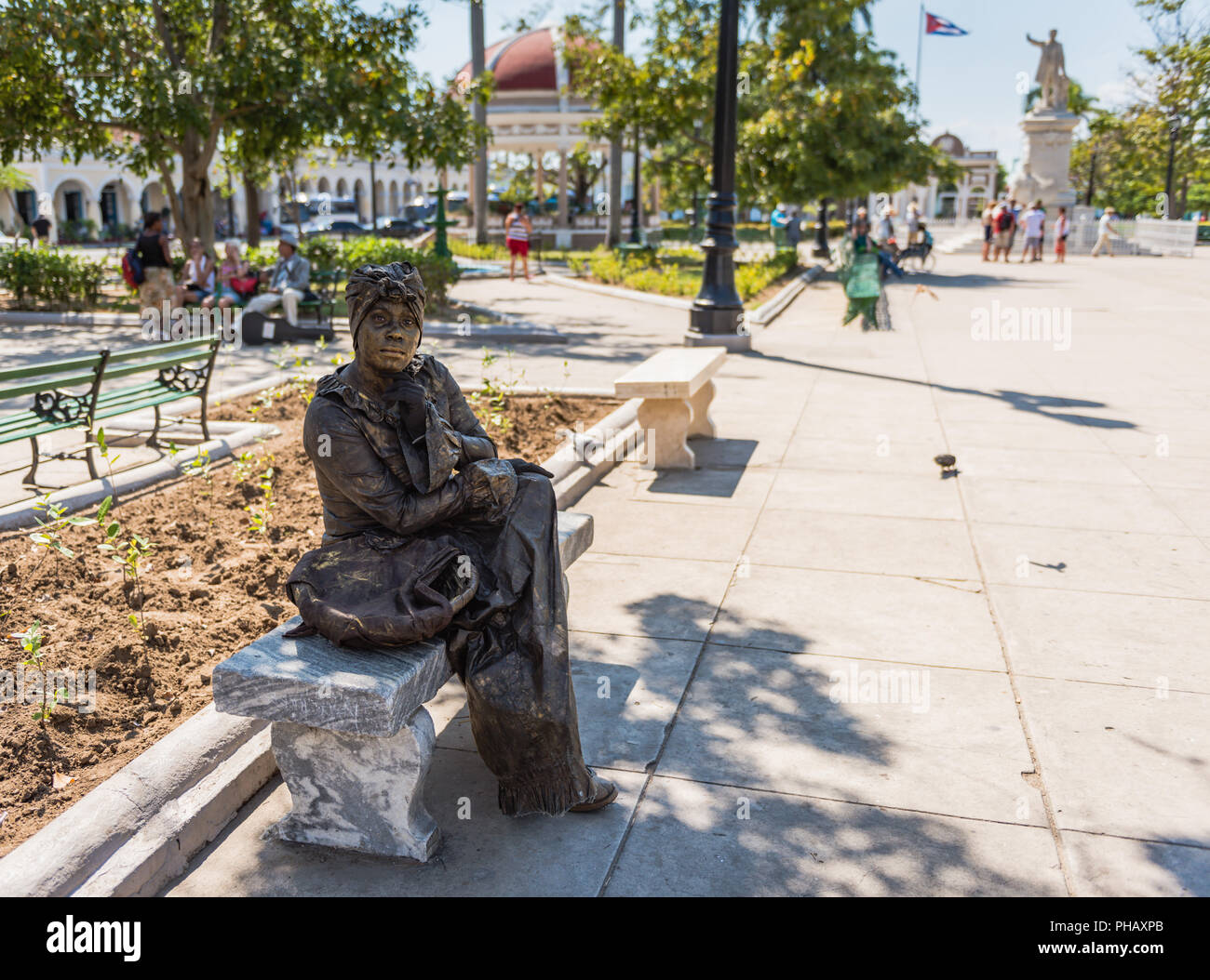 Cienfuegos, Cuba / March 15, 2016: Woman dressed to resemble bronze statue of a colonial era Cuban female. Stock Photo