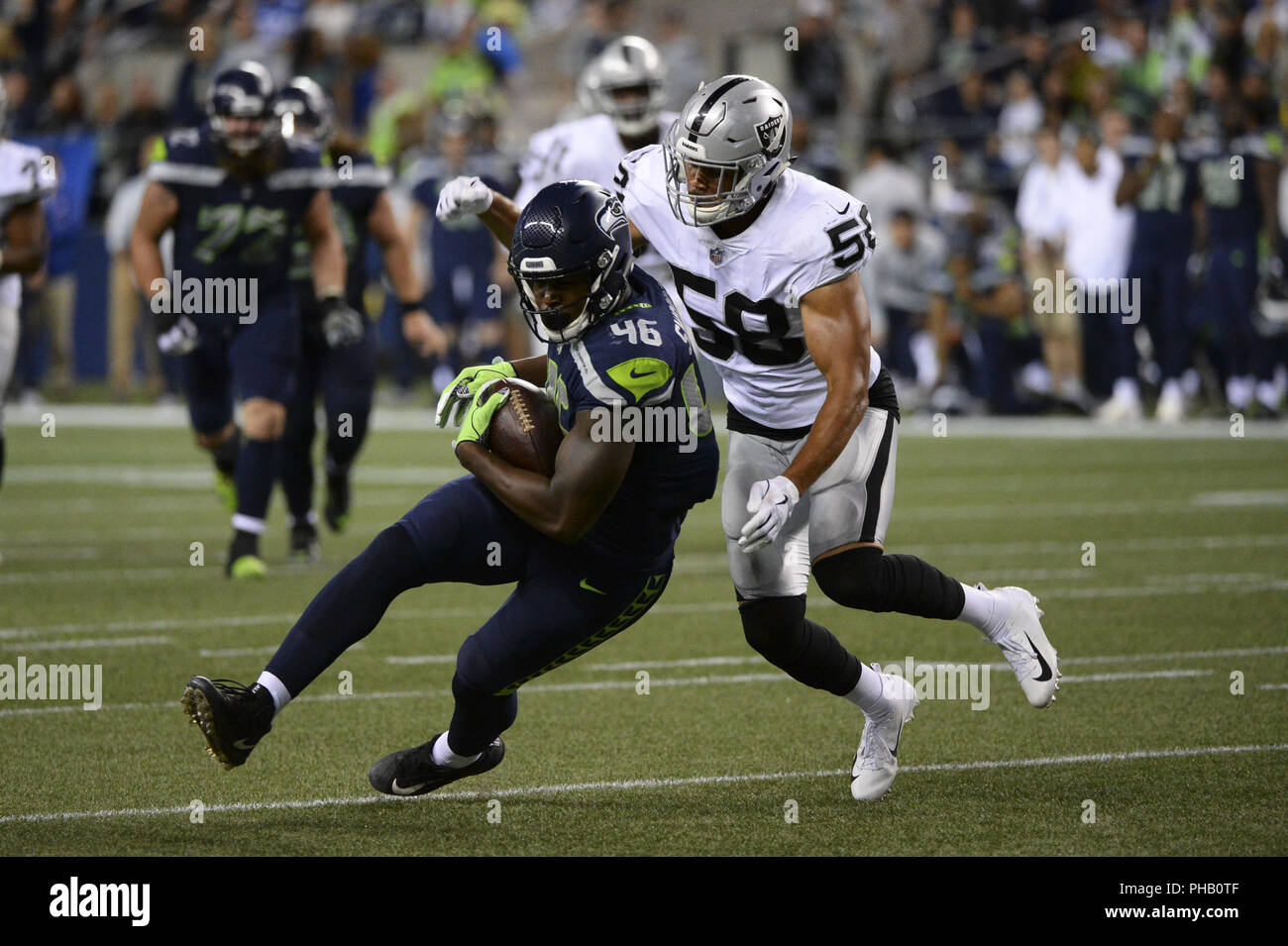 Seattle, Washington, USA. 30th Aug, 2018. Seattle tightend TYRON SWOOPES (46) grabs one of his two passes against linebacker KYLE WILBER (58) as the Oakland Raiders play the Seattle Seahawks in a preseason NFL game at Century Link Field in Seattle, WA. Credit: Jeff Halstead/ZUMA Wire/Alamy Live News Stock Photo