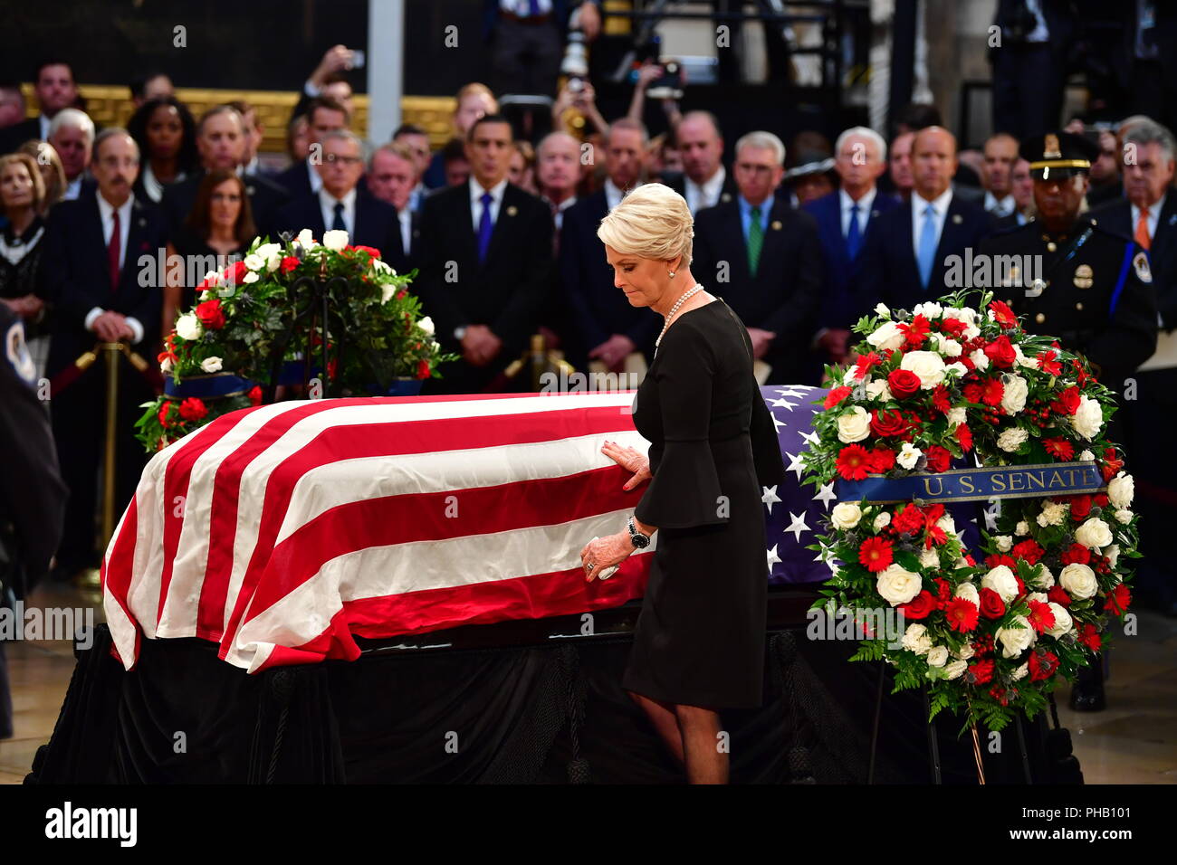 Cindy McCain touches the casket of former Senator John McCain in the Capitol Rotunda where he will lie in state at the U.S. Capitol, in Washington, DC on Friday, August 31, 2018. McCain, an Arizona Republican, presidential candidate and war hero died August 25th at the age of 81. He is the 31st person to lie in state at the Capitol in 166 years. Photo by Kevin Dietsch/UPI | usage worldwide Stock Photo