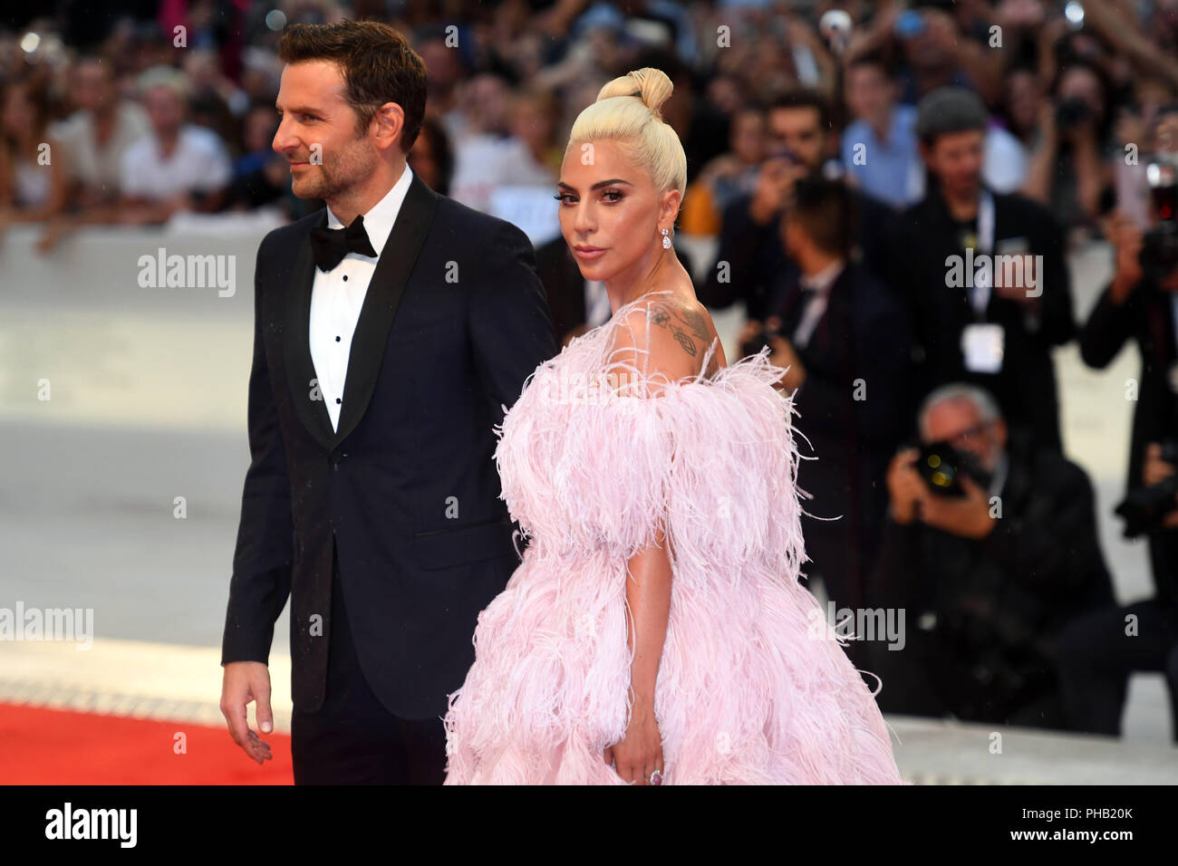 Venice, Italy. 31st Aug, 2018. The singer Lady Gaga and the actor and director Bradley Cooper walk the red carpet at the world premiere of the film musical 'A Star is Born' at the Venice Film Festival. The film festival runs from 29 August to 8 September and is taking place for the 75th time this year. Credit: Felix Hörhager/dpa/Alamy Live News Stock Photo