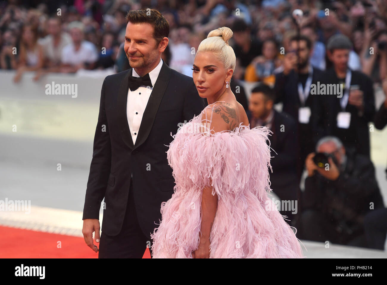Venice, Italy. 31st Aug, 2018. The singer Lady Gaga and the actor and director Bradley Cooper walk the red carpet at the world premiere of the film musical 'A Star is Born' at the Venice Film Festival. The film festival runs from 29 August to 8 September and is taking place for the 75th time this year. Credit: Felix Hörhager/dpa/Alamy Live News Stock Photo