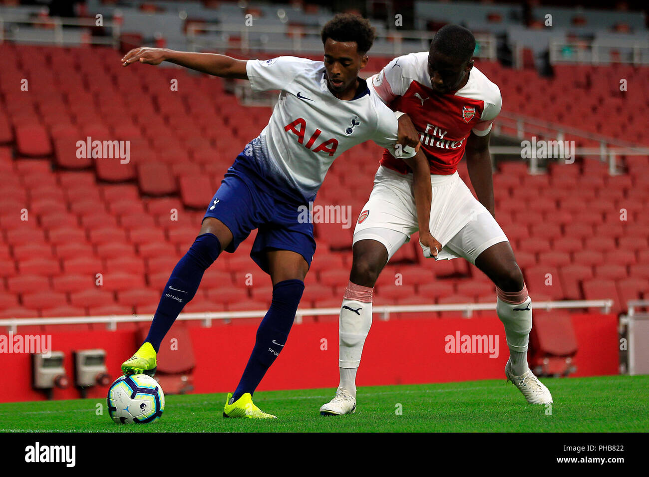 London, UK. 31st August 2018. Tashan Oakley-Boothe of Tottenham (L) in  action with Joseph Olowu of Arsenal (R). PL2 match, Arsenal U23's v  Tottenham Hotspur U23's at the Emirates Stadium in London