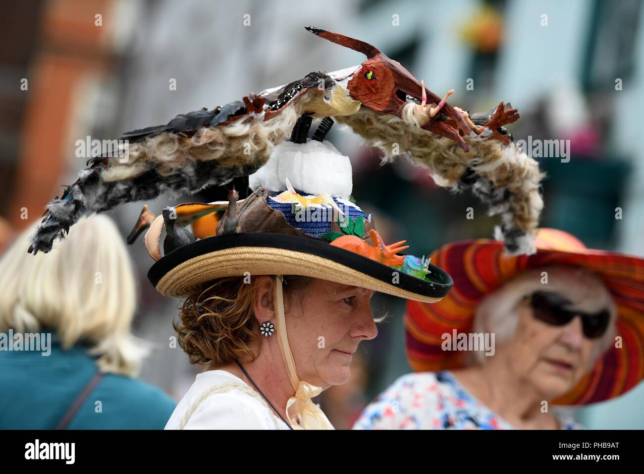 Bridport, UK. 1st September 2018. Bridport Hat Festival, Dorset, UK, Pterodactyl hat Barbara Burnett Credit: Finnbarr Webster/Alamy Live News Stock Photo
