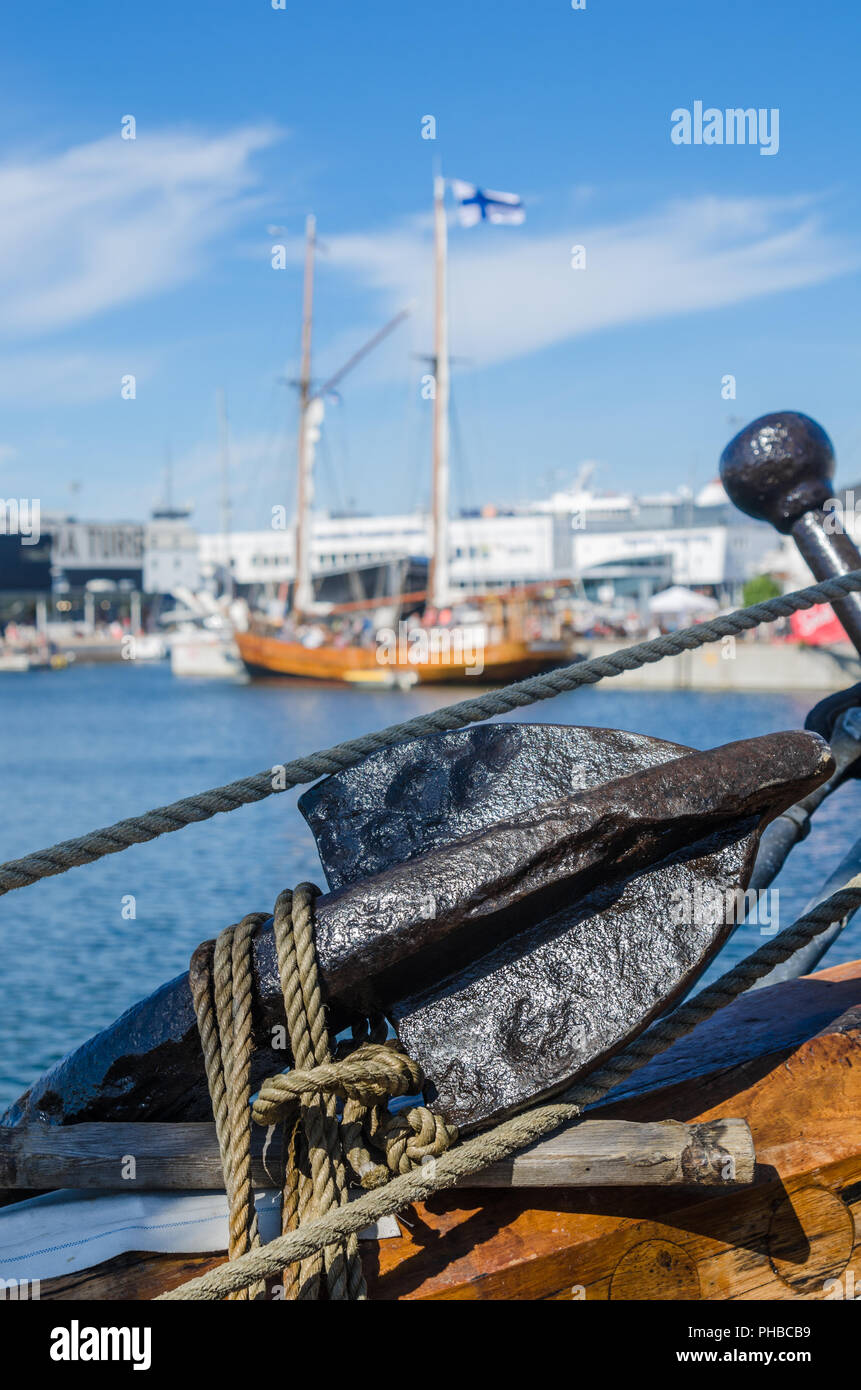 Old rusty anchor at a board of the old sailboat Stock Photo