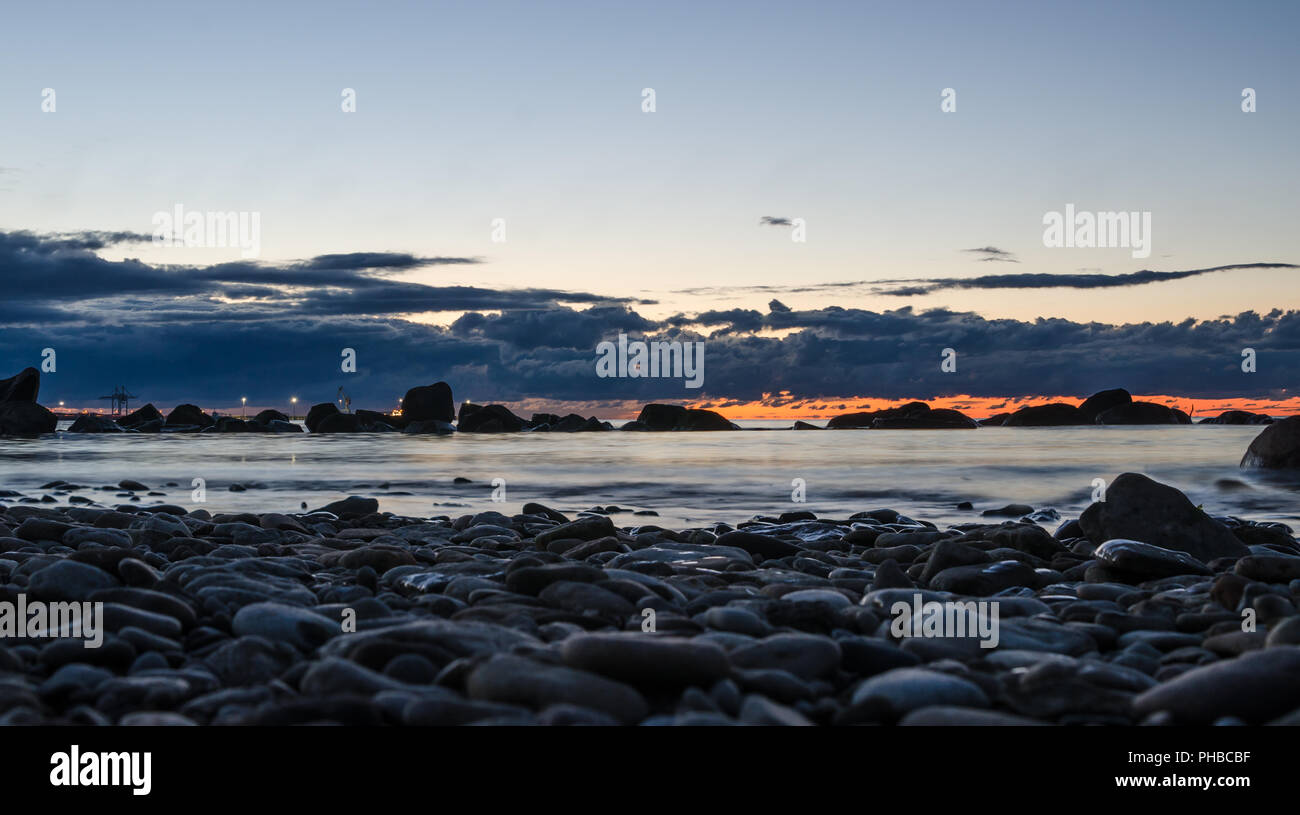 Sunset on the Baltic Sea, stony shore Stock Photo