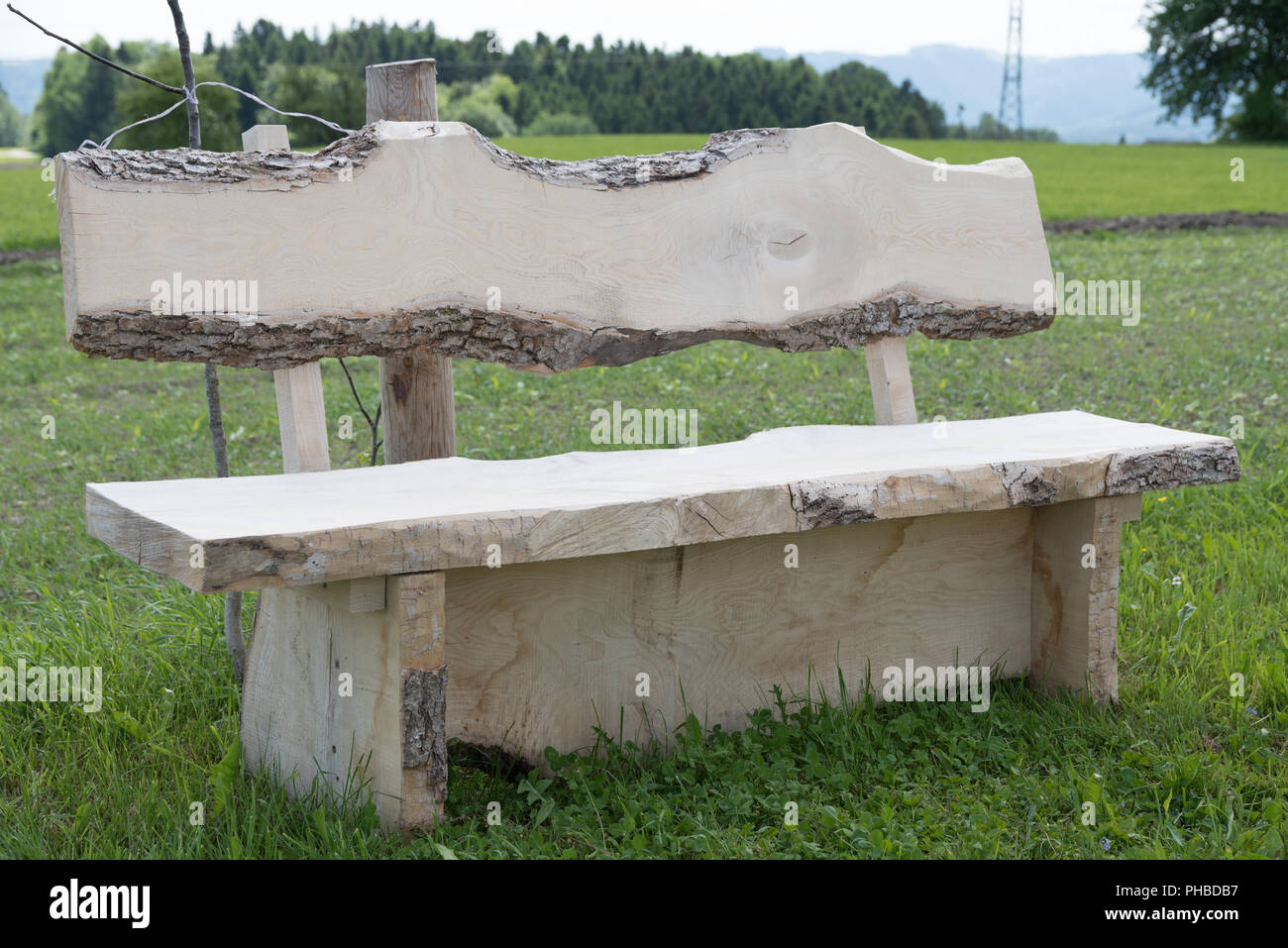 Rustic garden bench made of solid hardwood Stock Photo