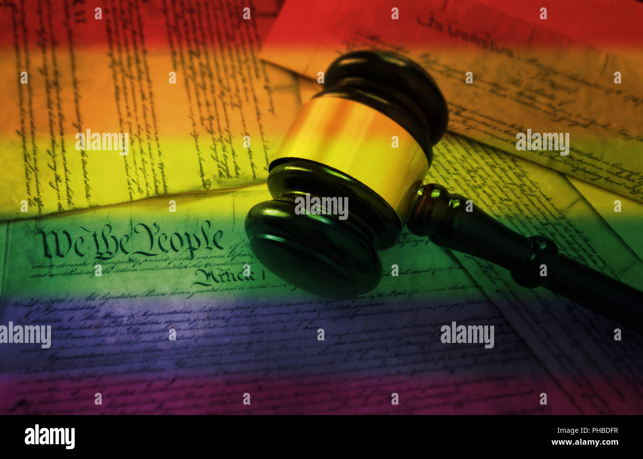 Rainbow flag gavel on America's Constitution Stock Photo