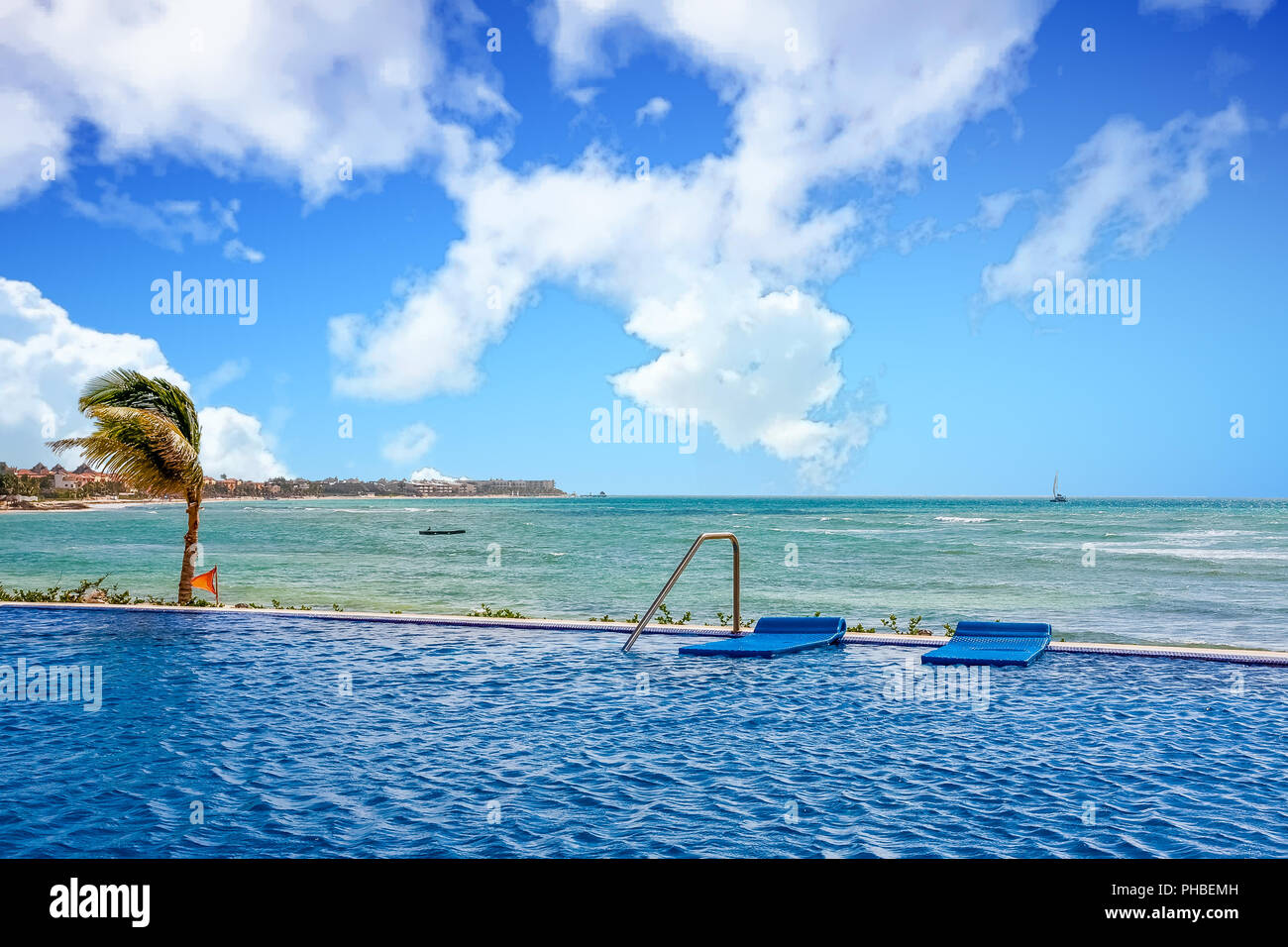 Blue floats at the edge of a pool next to the sea Stock Photo - Alamy
