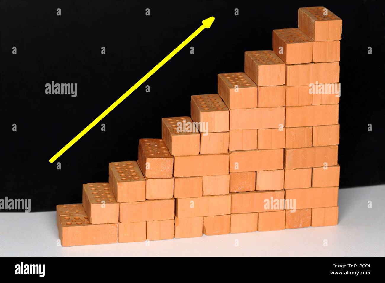growing symbol with bricks Stock Photo - Alamy