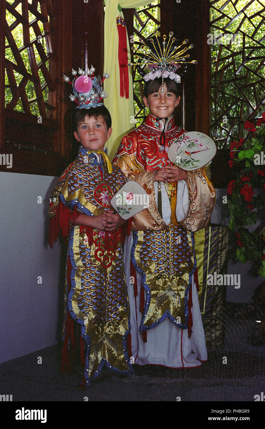 Two children dressed up in traditional Chinese costume, Chinese Garden of Friendship, Darling Harbour, Sydney, NSW, Australia.  MODEL  RELEASED Stock Photo