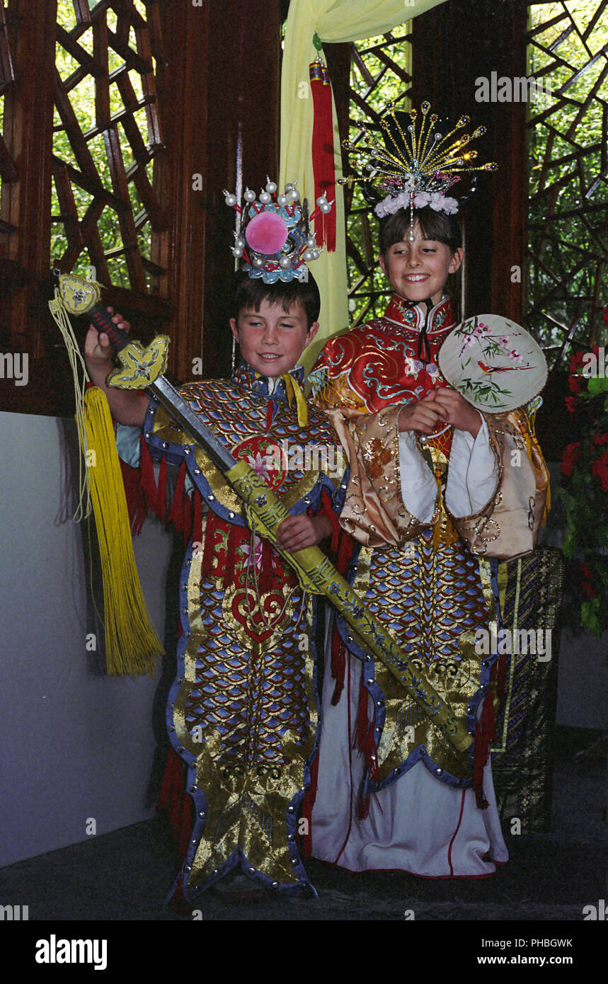 Two children dressed up in traditional Chinese costume, Chinese Garden of Friendship, Darling Harbour, Sydney, NSW, Australia.  MODEL RELEASED Stock Photo