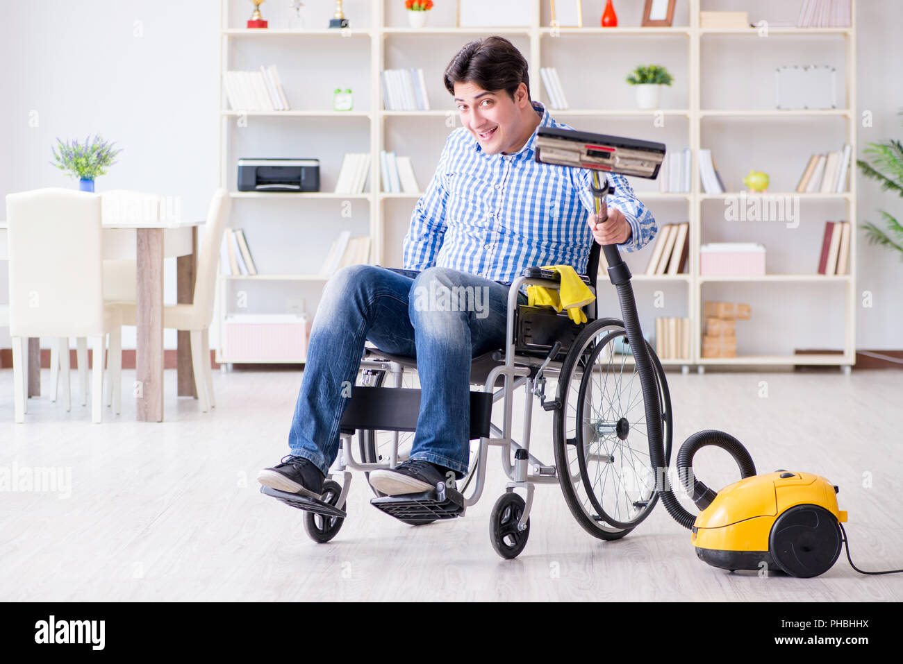 Disabled man cleaning home with vacuum cleaner Stock Photo Alamy