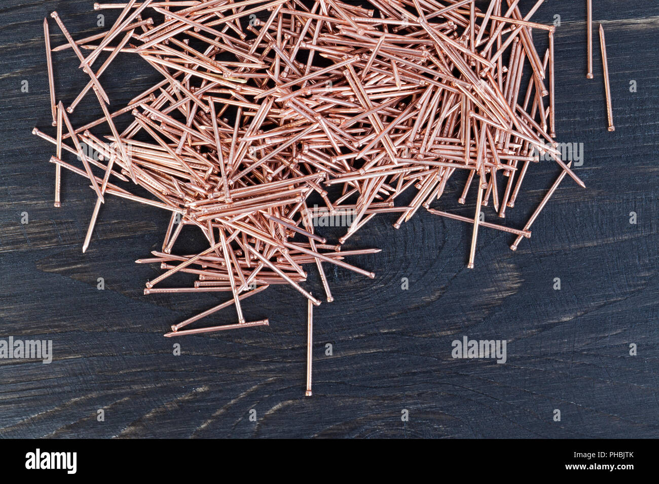 a pile of small metal nails made or processed with copper for finishing  work with wood, closeup Stock Photo - Alamy