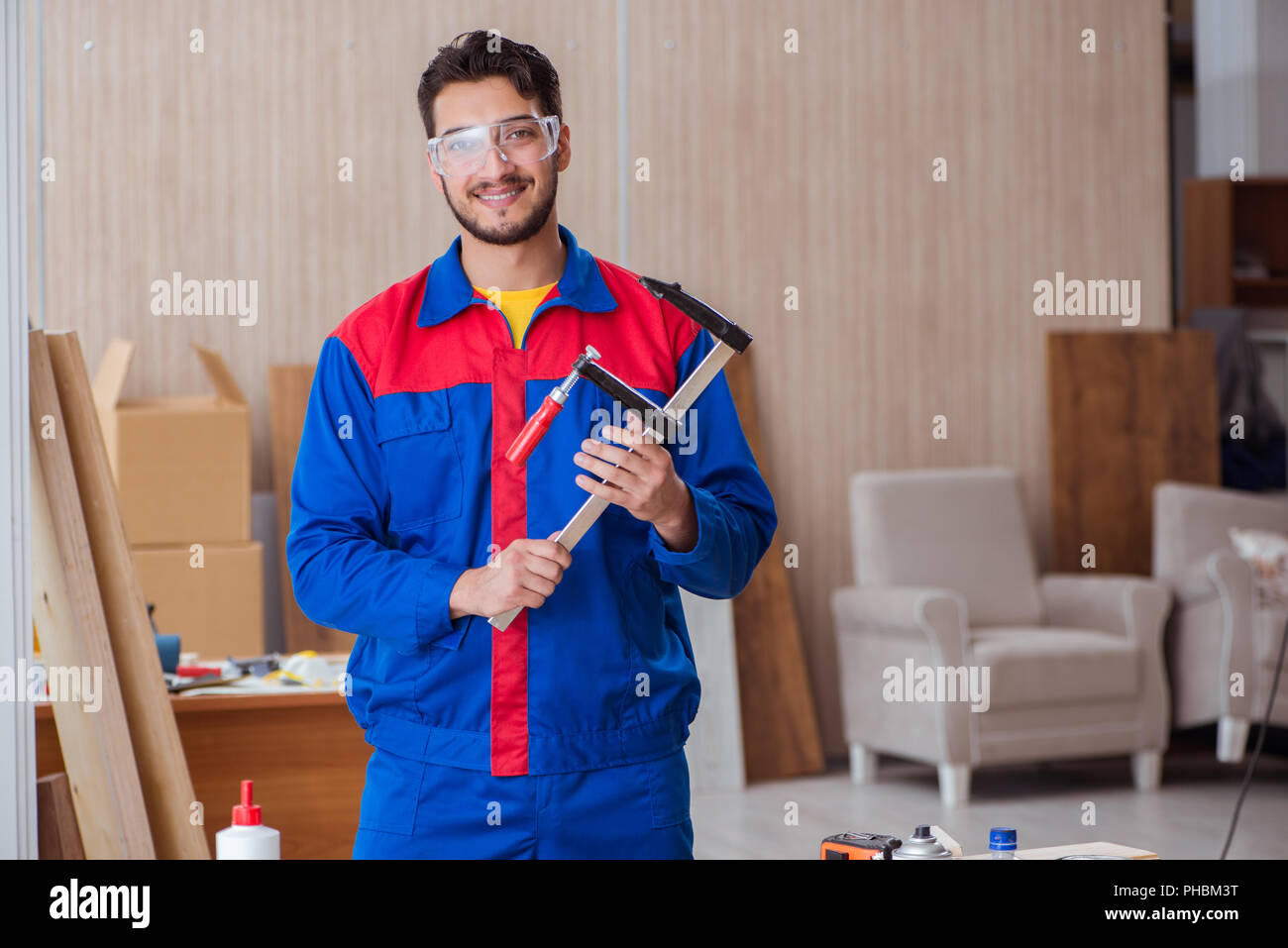Young repairman carpenter working with clamps Stock Photo