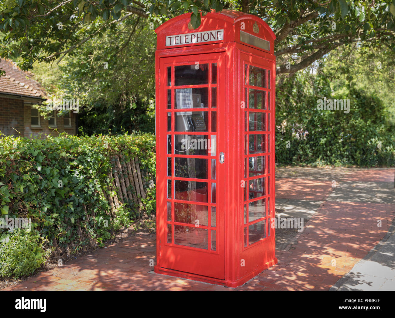Classical red telephone booth in English trees, United Kingdom Stock ...