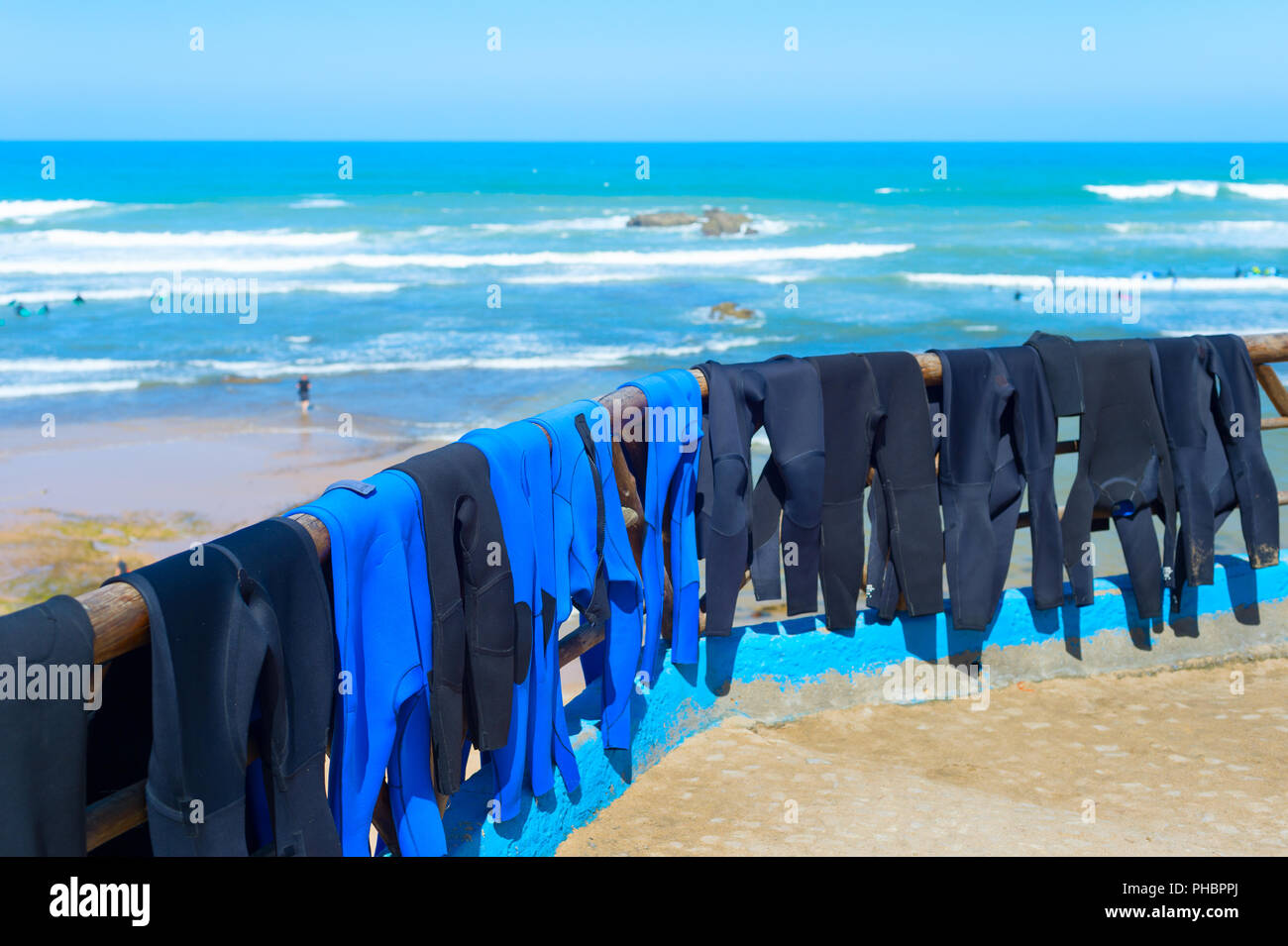 Surfers wetsuits drying on beach Stock Photo Alamy