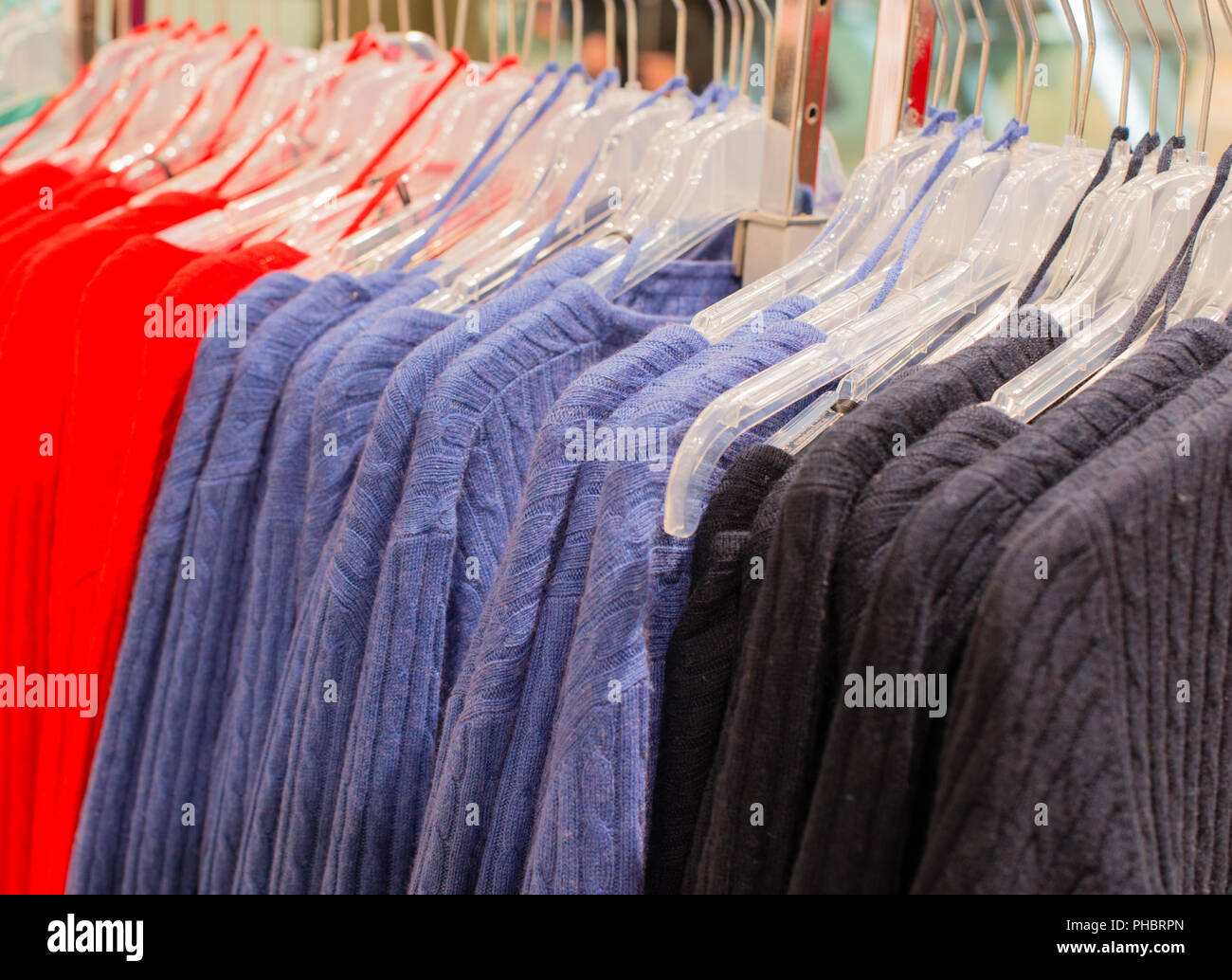 Colorful cashmere sweater on a clothes rack Stock Photo