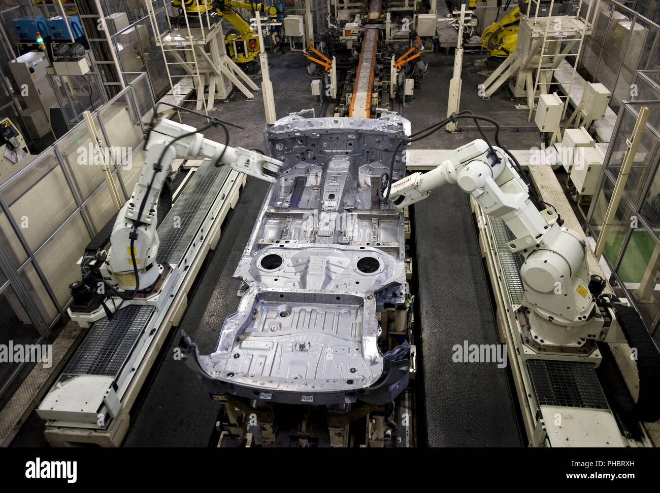 Robots work on a vehicle at Nissan Motor Co.s assembly plant in Tochigi, Japan on Thursday 12 Nov.  2009.  Photographer: Robert Gilhooly Stock Photo