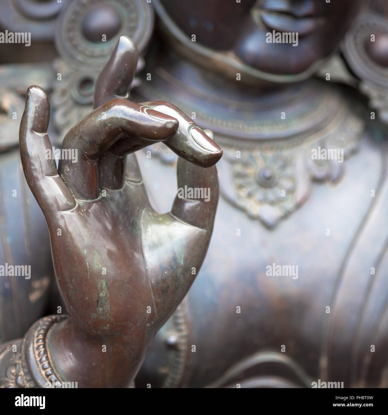 Detail of Buddha statue with Karana mudra hand position Stock Photo